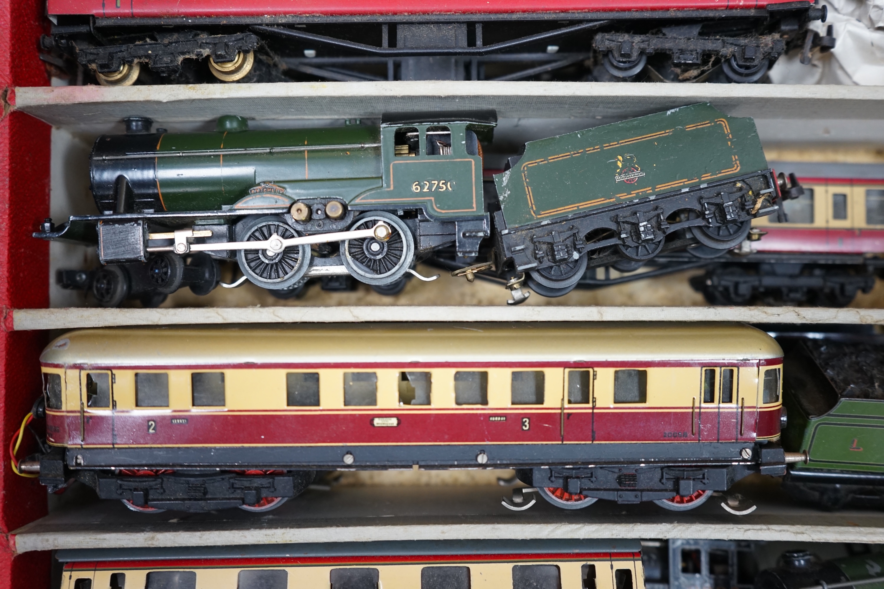 A Trix Twin Railway 00 gauge train set box containing; four locomotives, eight bogie coaches, two railcars, and six freight wagons, together with a live steam Marklin 0-4-0T LNER locomotive. Condition - poor to fair.